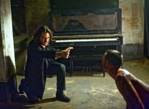 Mendoza (EDGAR RAMIREZ) holds off the attacking Jimmy (CHRIS COY) with the power of the crucifix, prayer and holy water.